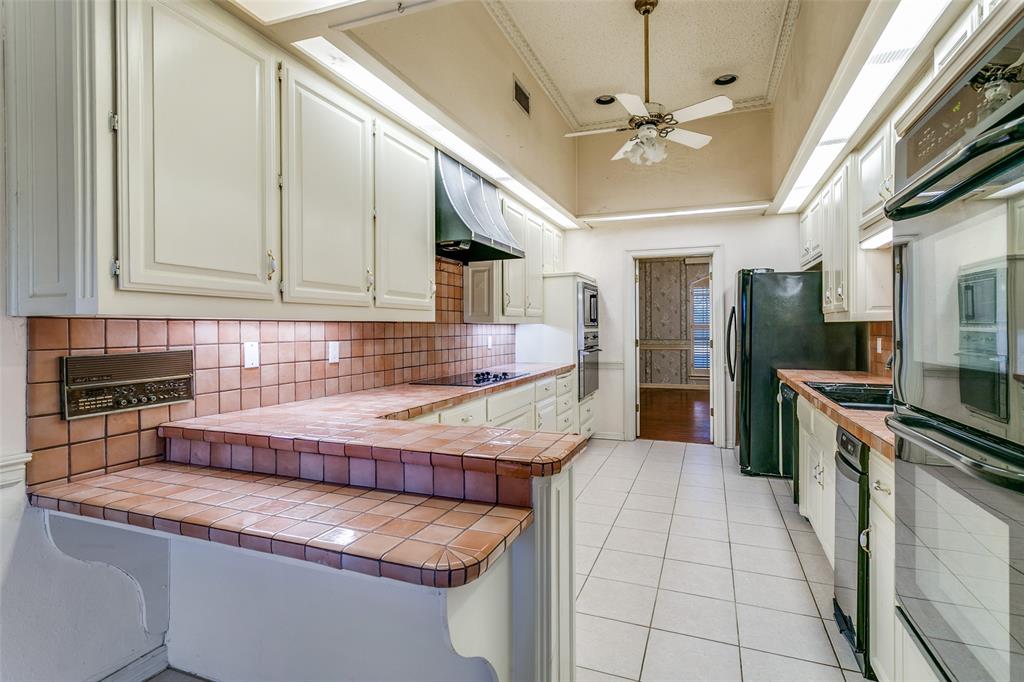 1920 Pearson Crossing Keller, TX 76248 - Photo 11 of 25 a kitchen with stainless steel appliances granite countertop a sink stove and refrigerator