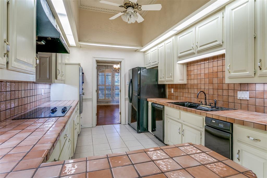1920 Pearson Crossing Keller, TX 76248 - Photo 12 of 25 a kitchen with a sink a stove cabinets and refrigerator