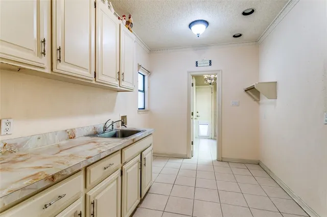 a kitchen with a sink and cabinets