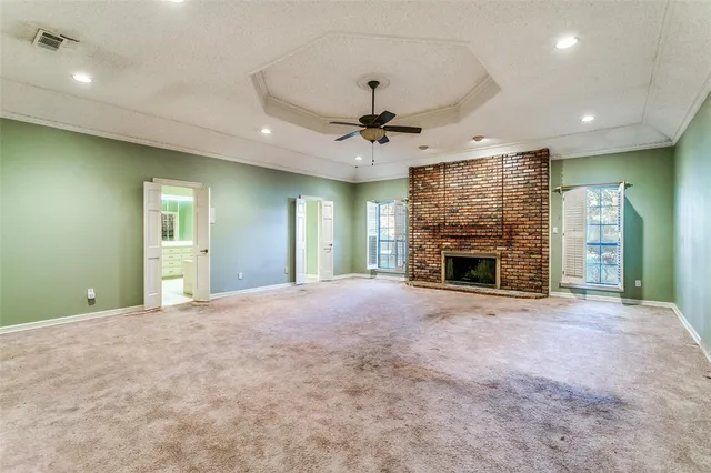 a view of an empty room with a fireplace