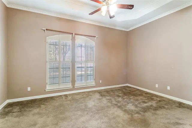 an empty room with chandelier fan