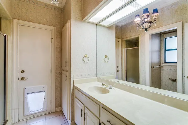 a bathroom with a sink shower and a mirror
