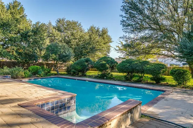 a view of a swimming pool with a yard