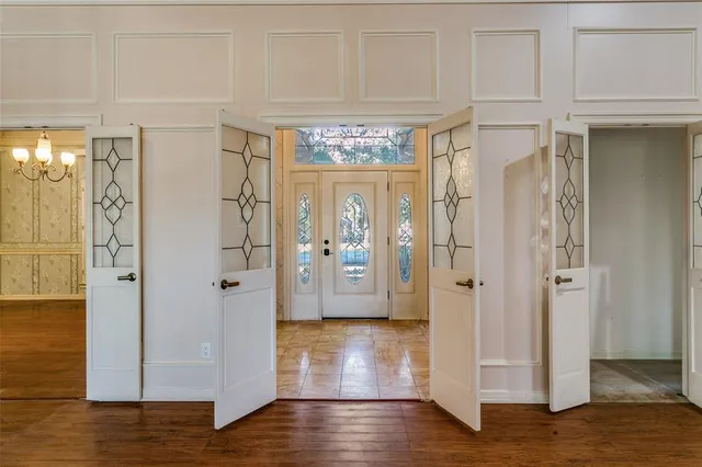 a view of a hallway with wooden floor