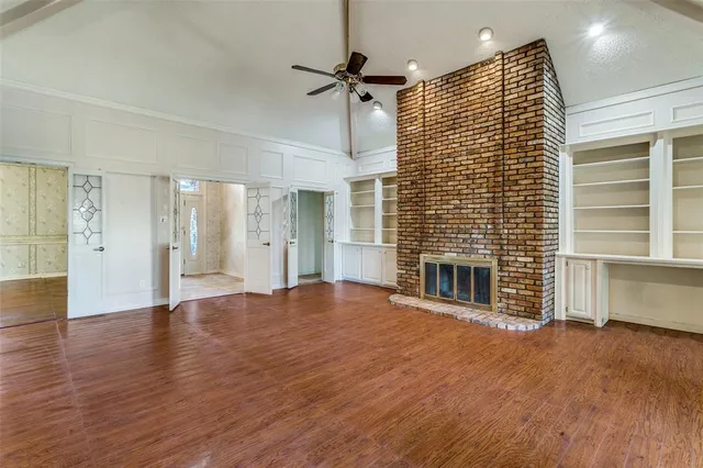 a view of a livingroom with wooden floor and a ceiling fan