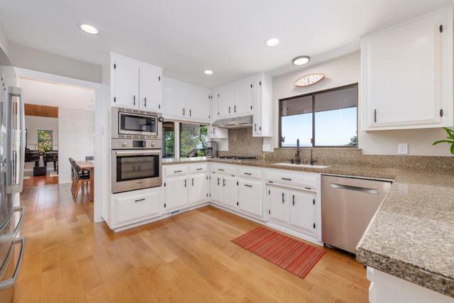 a bedroom with a bed and a large window with outer view