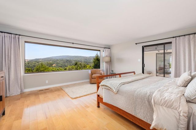 a living room with furniture and a floor to ceiling window