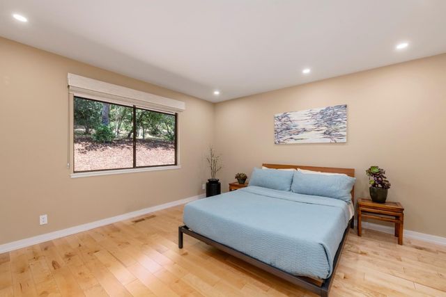 a backyard of a house with table and chairs under an umbrella