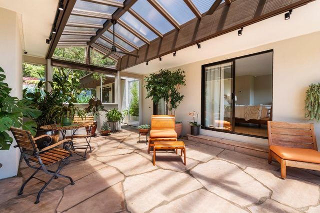 a view of a balcony with wooden floor and outdoor seating