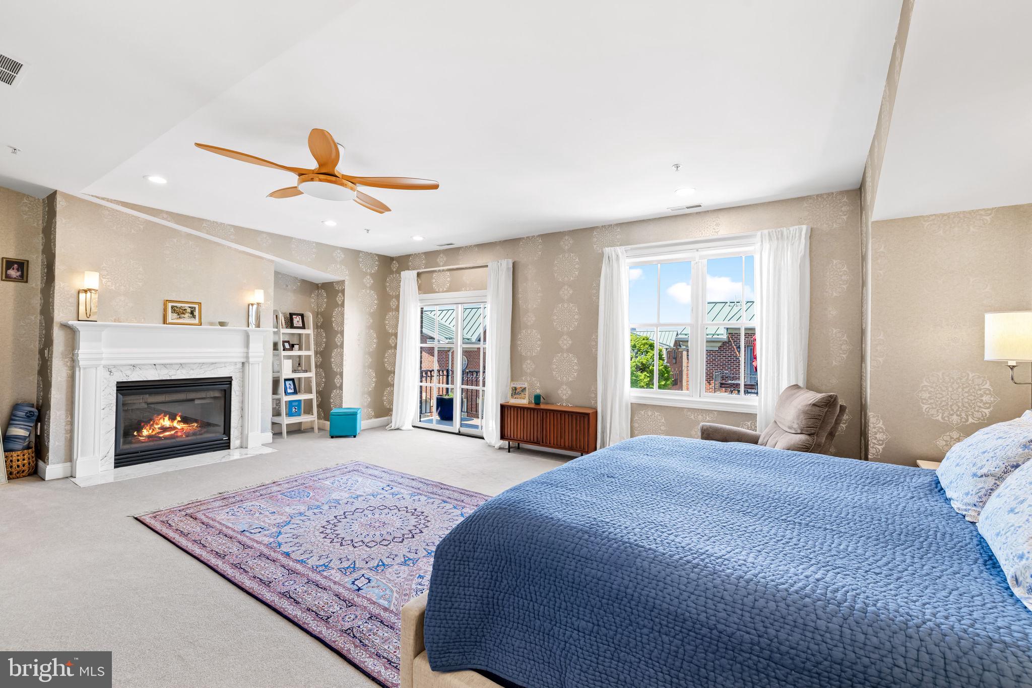 2331 Boston Street, Unit 1 Baltimore, MD 21224 - Photo 51 of 74 a spacious bedroom with a large bed and a fireplace