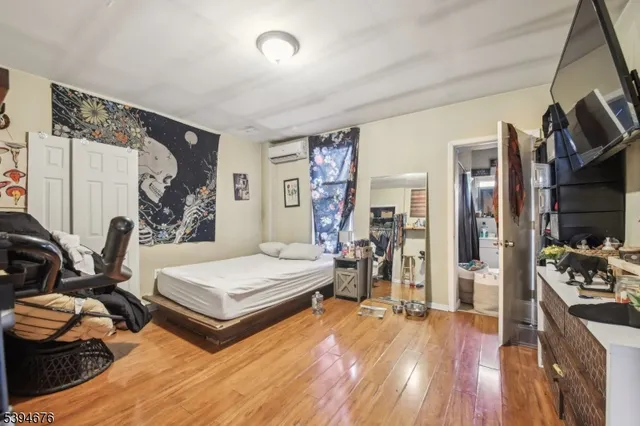 a bedroom with furniture and a wooden floor