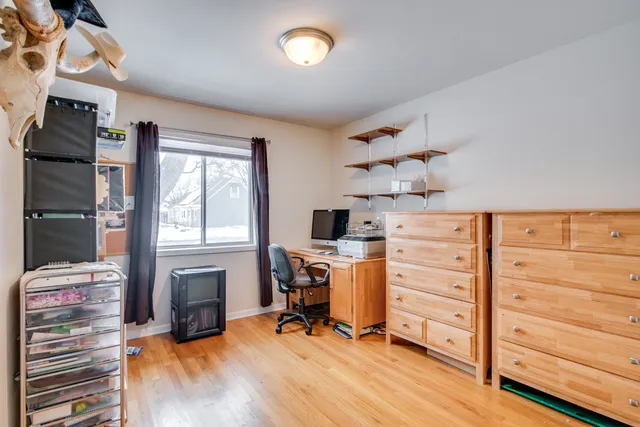 a view of a workspace with furniture and a window