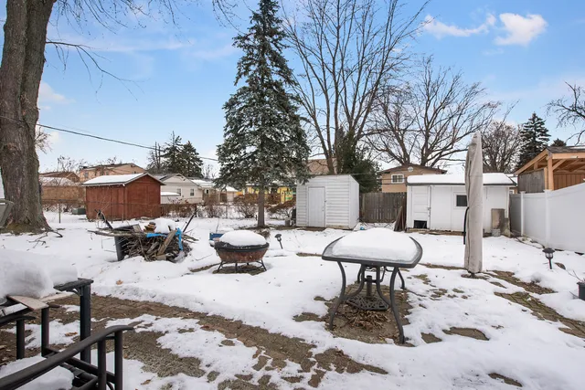 a view of a back yard of the house with sitting space
