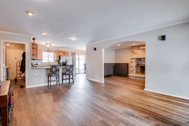 a view of a kitchen with dining room and wooden floor
