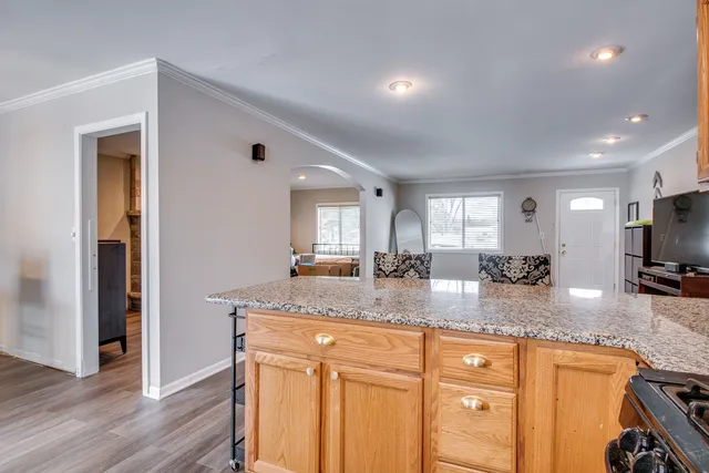 a kitchen with granite countertop a sink and cabinets