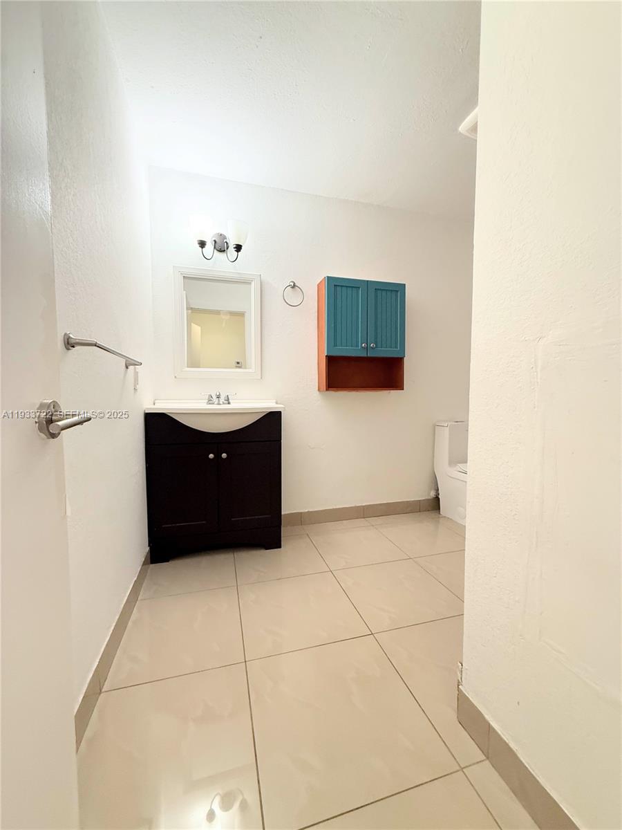 2950 Griffin Road, Unit 3 Dania Beach, FL 33312 - Photo 2 of 13 a bathroom with a sink vanity and mirror
