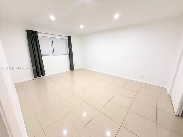 a view of an empty room and a window