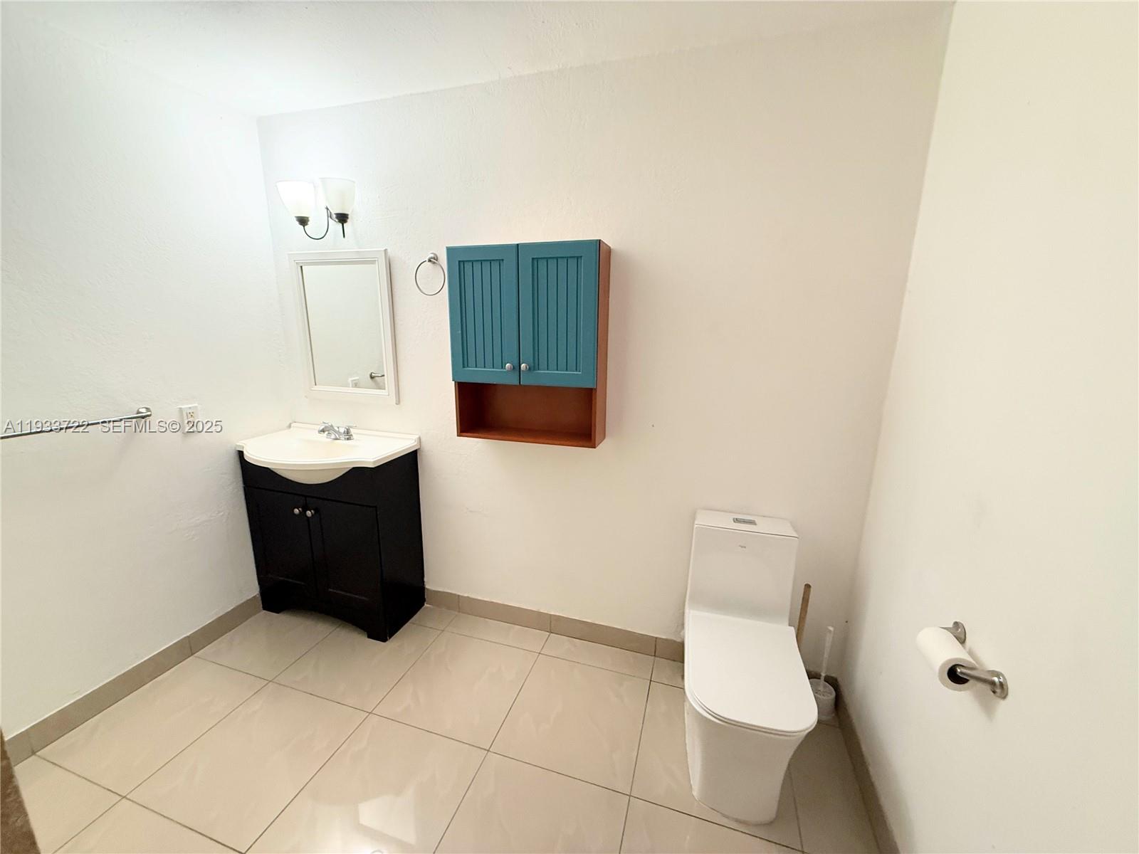 2950 Griffin Road, Unit 3 Dania Beach, FL 33312 - Photo 10 of 13 a bathroom with a toilet sink and mirror