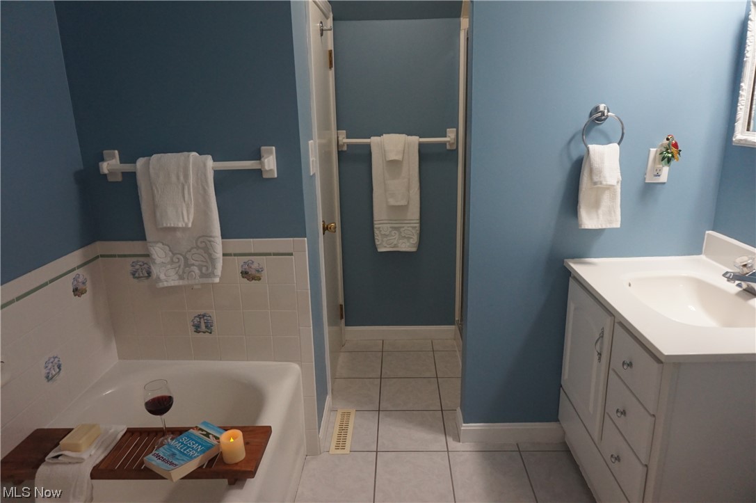 7311 Lake Road East Madison, OH 44057 - Photo 13 of 35 Bathroom features soaking tub, shower, double entry and ceramic tile floors.