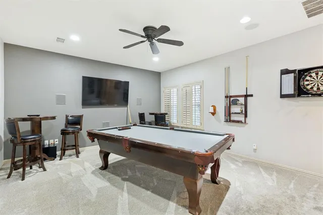 a room with furniture pool table and flat screen tv