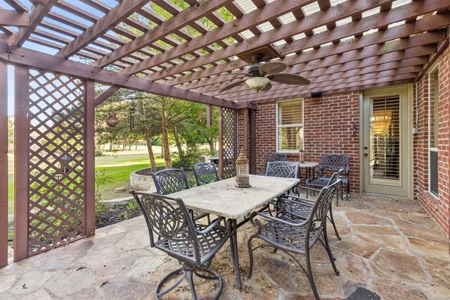 a view of a patio with a table and chairs