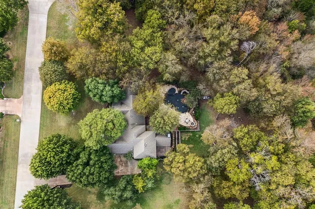 an aerial view of a house with yard and outdoor seating