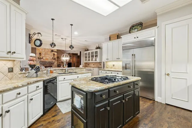 a kitchen with a stove a sink and a refrigerator