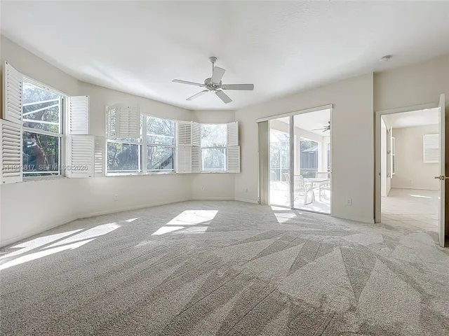 a view of a big room with closet and a chandelier fan