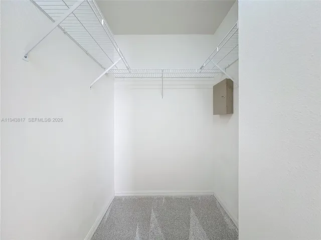 a bathroom with a granite countertop sink mirror and toilet