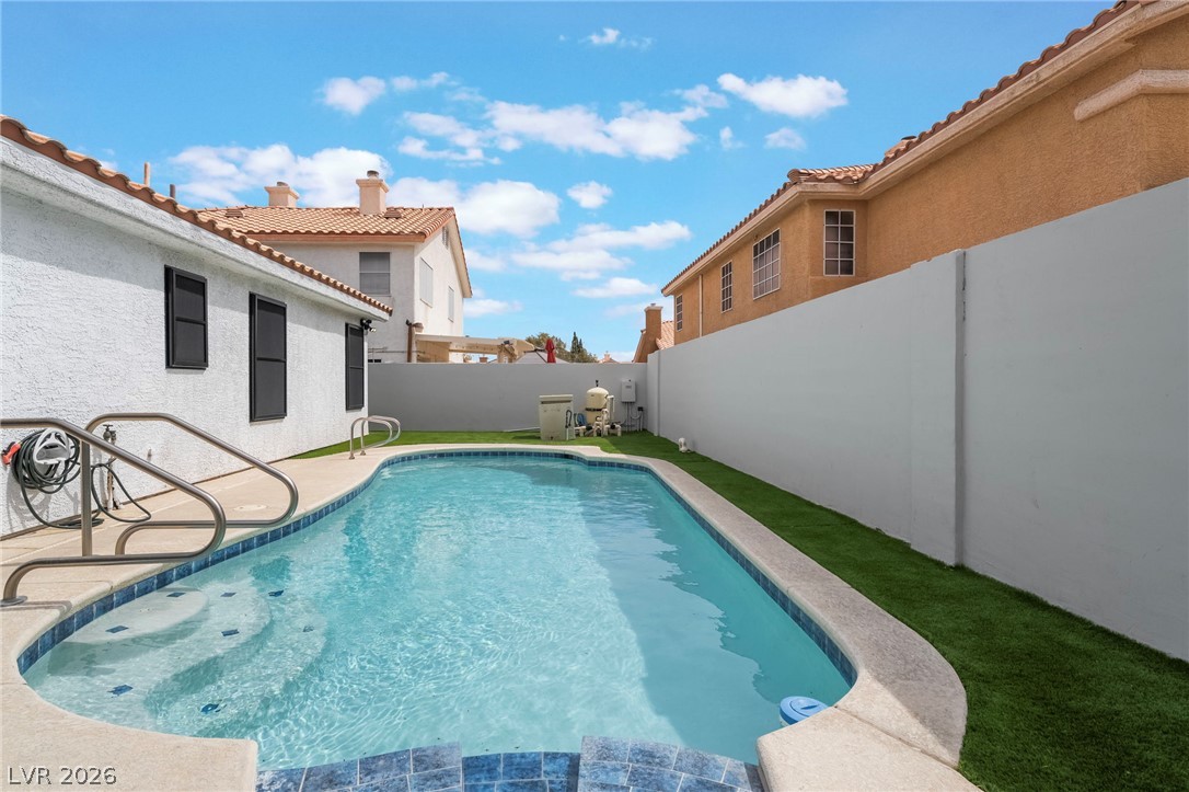 9171 West Viking Road Las Vegas, NV 89147 - Photo 40 of 43 A private swimming pool offers a refreshing escape within a secluded yard.
