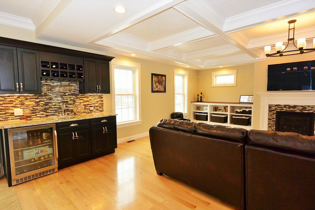 142 Chace Hill Road Lancaster, MA 01523 - Photo 3 of 30 a living room with furniture a flat screen tv and a fireplace
