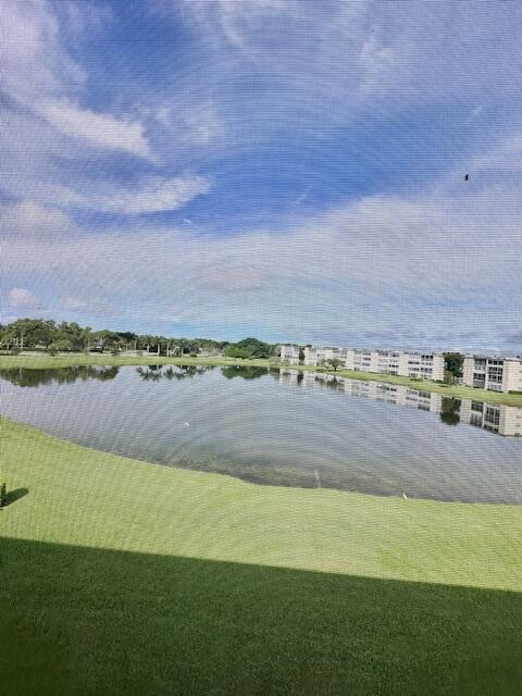 4091 Cornwall East, Unit 4091 Boca Raton, FL 33434 - Photo 14 of 27 a view of a lake with a building in the background