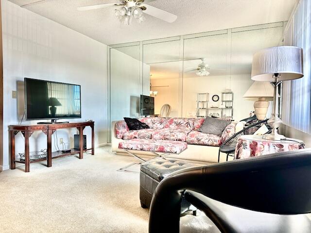 4091 Cornwall East, Unit 4091 Boca Raton, FL 33434 - Photo 5 of 27 a living room with a couch and a flat screen tv