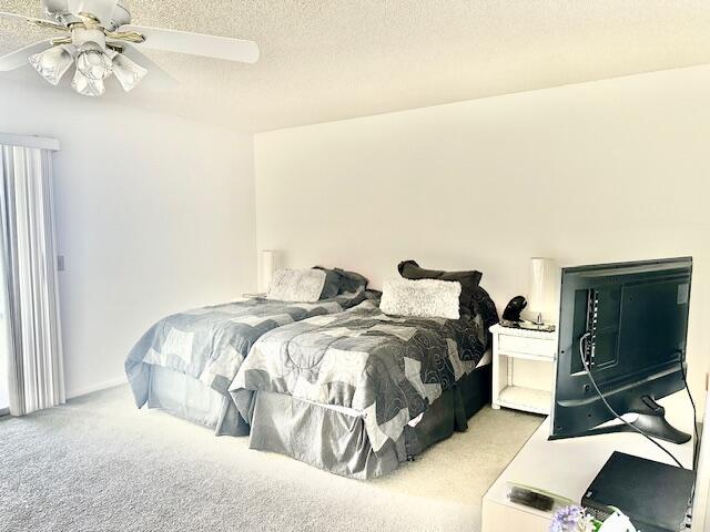 4091 Cornwall East, Unit 4091 Boca Raton, FL 33434 - Photo 9 of 27 a bedroom with a bed and a chandelier