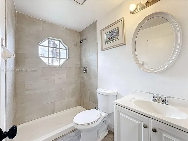 a white toilet sitting next to a bathroom sink