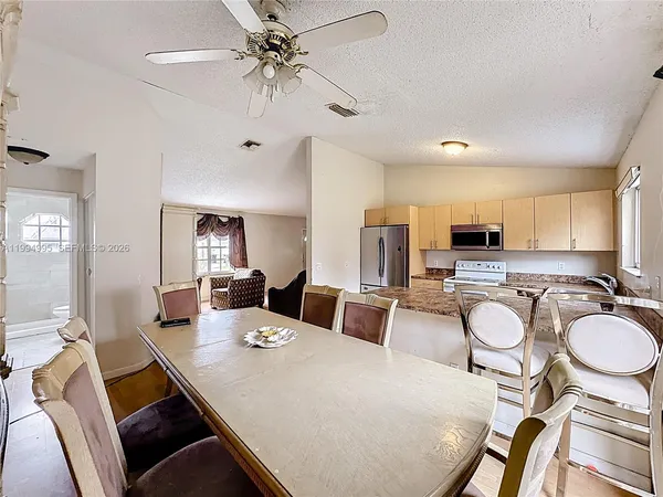 a view of a dining room with furniture and a chandelier