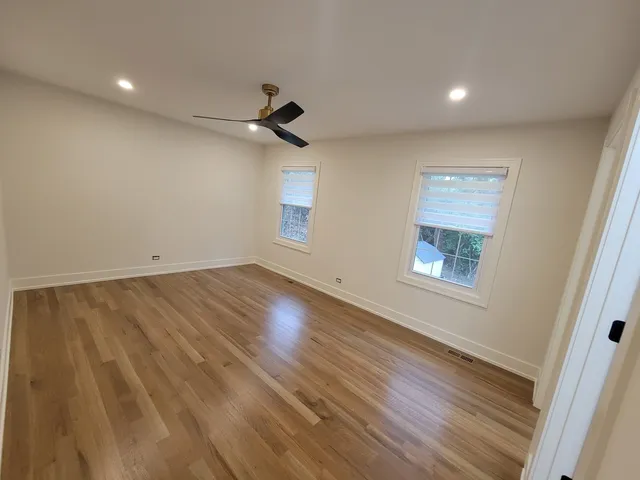 wooden floor in an empty room with a window