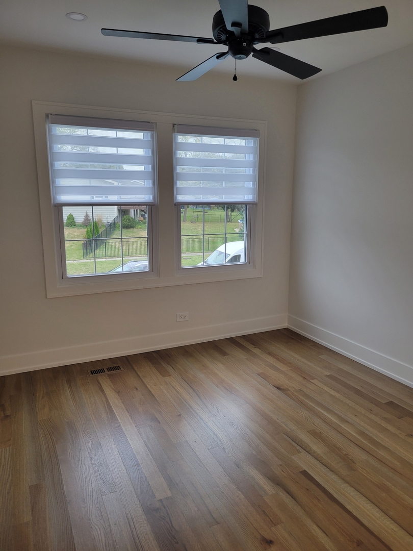 2S245 Mayfield Lane Glen Ellyn, IL 60137 - Photo 20 of 26 a view of an empty room with wooden floor and a window