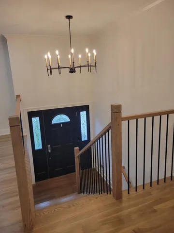 a view of entryway and hall with wooden floor
