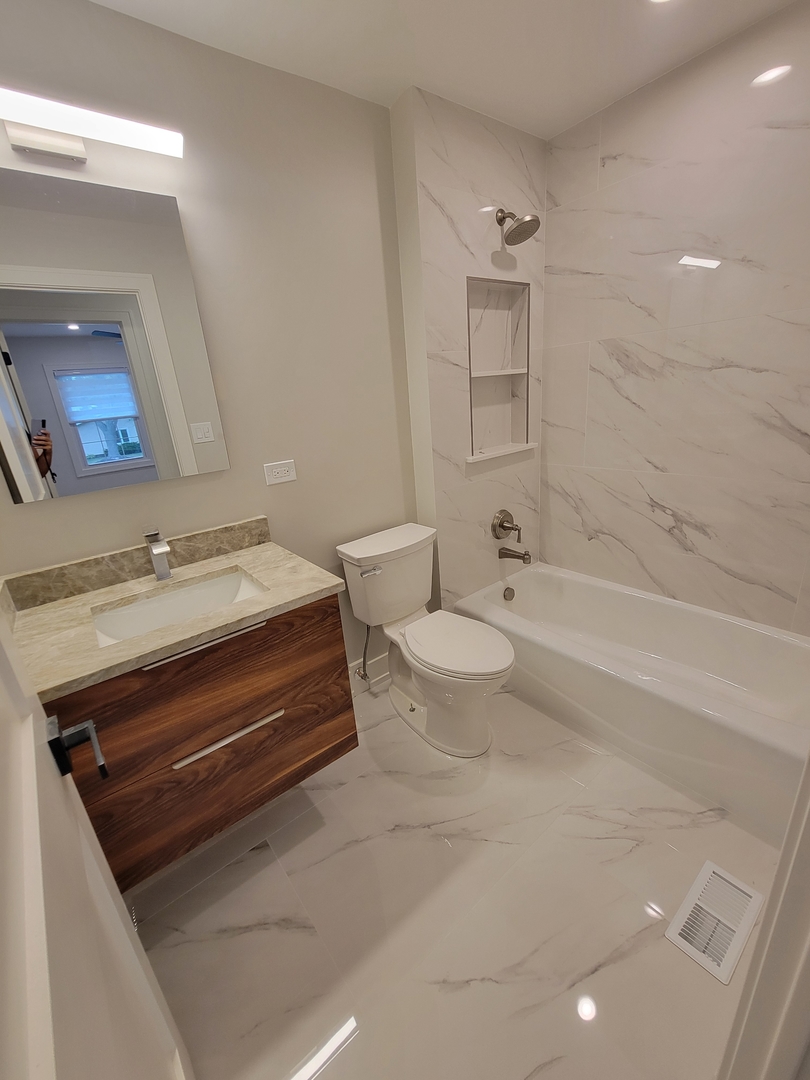 2S245 Mayfield Lane Glen Ellyn, IL 60137 - Photo 21 of 26 a bathroom with a sink a toilet and shower