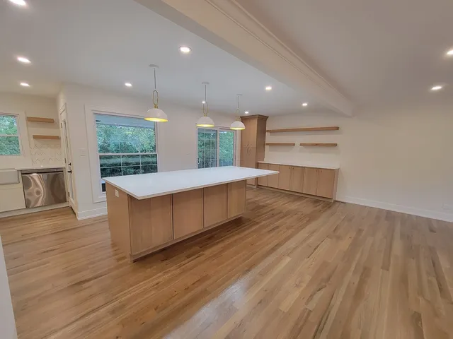 a kitchen with a wooden floor and window