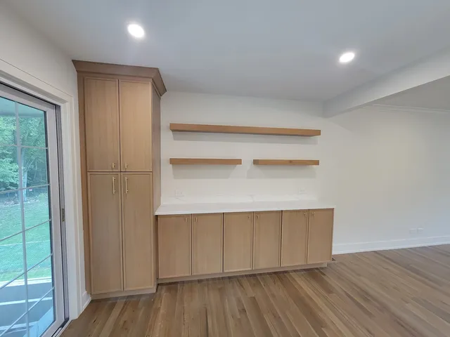 a hallway with wooden floor and closet