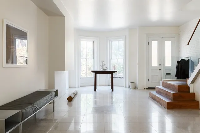 a view of a livingroom with furniture and a flat screen tv