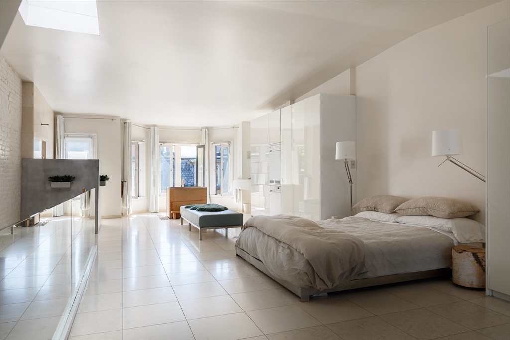 80 Appleton Street Boston, MA 02116 - Photo 16 of 30 a bedroom with a bed and large windows