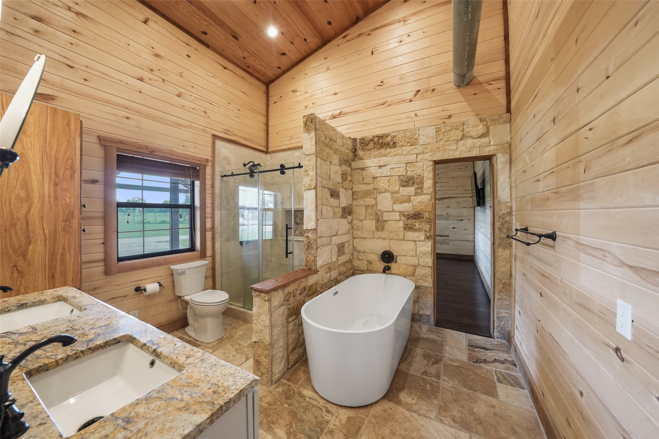 26534 Mitchell Road Hempstead, TX 77445 - Photo 23 of 45 a bathroom with a granite countertop sink and mirror bathtub