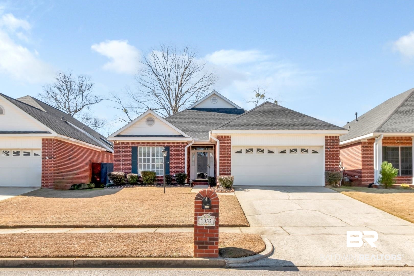 1032 Cross Gates Place Mobile, AL 36609 - Photo 1 of 34 Ranch-style home with roof with shingles, driveway, brick siding, and an attached garage