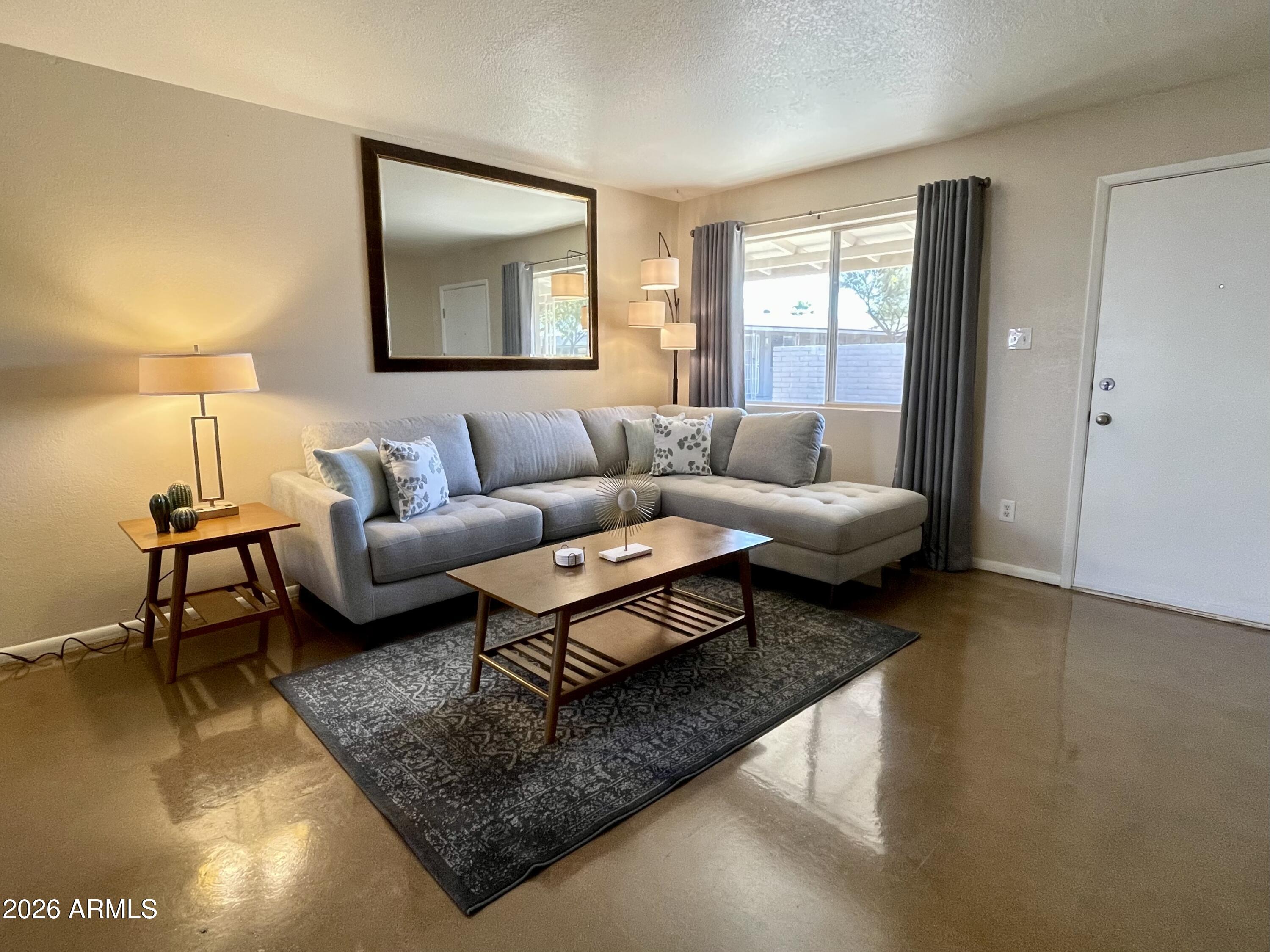 a living room with furniture and a rug