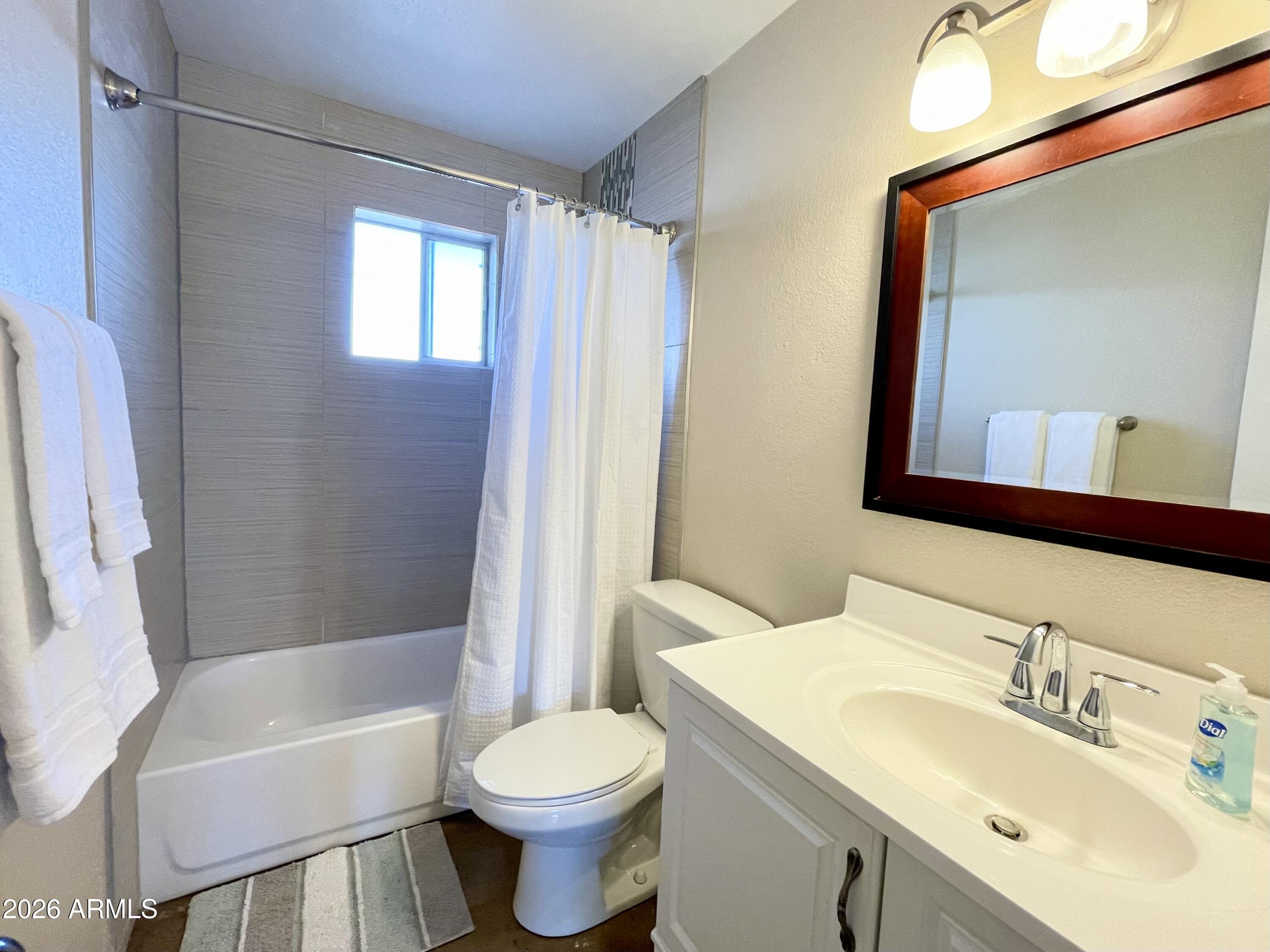 6819 North 12th Street, Unit 9 Phoenix, AZ 85014 - Photo 11 of 21 a bathroom with a sink toilet a mirror and shower