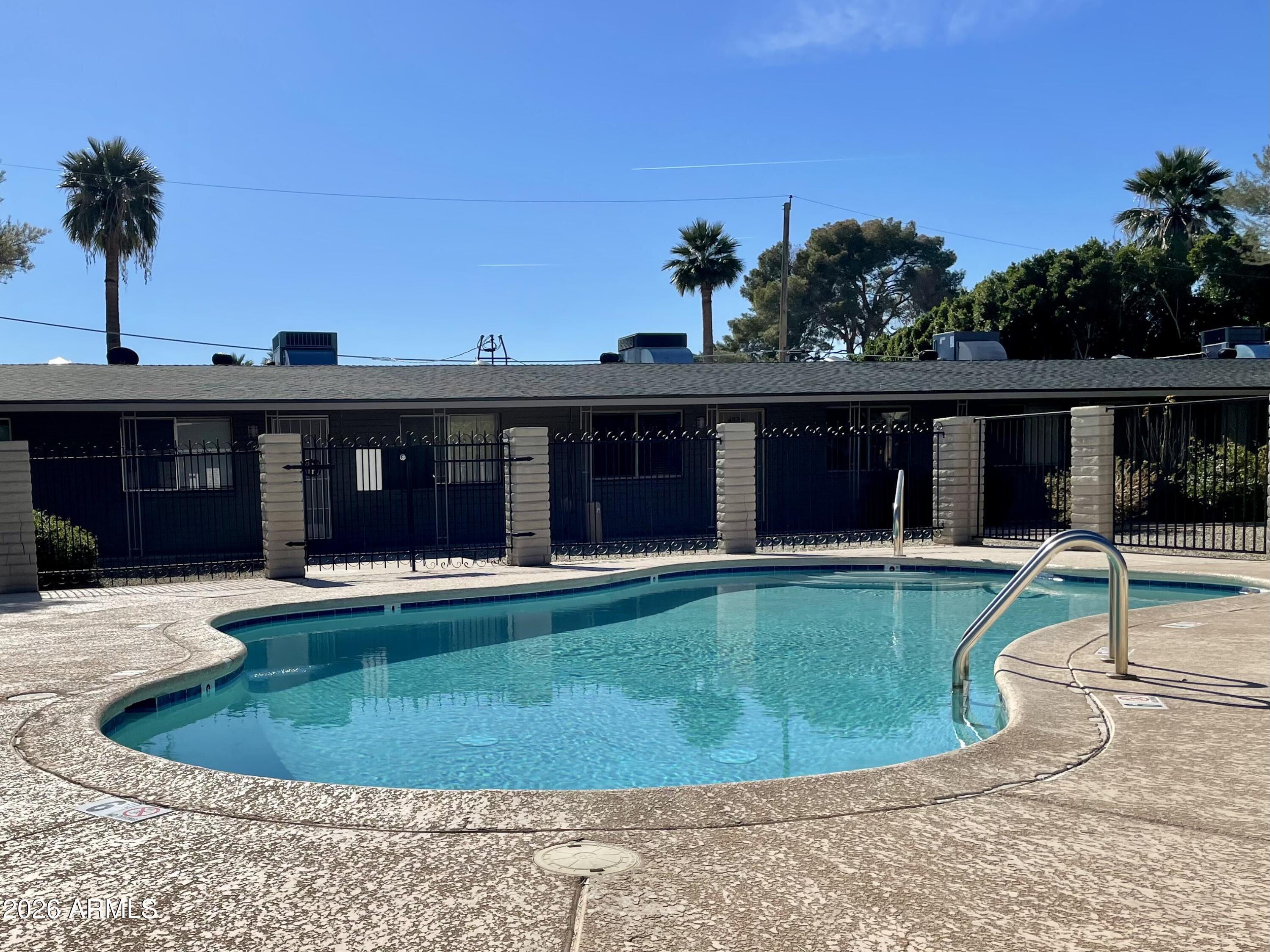 6819 North 12th Street, Unit 9 Phoenix, AZ 85014 - Photo 15 of 21 a view of a house with a swimming pool and sitting area