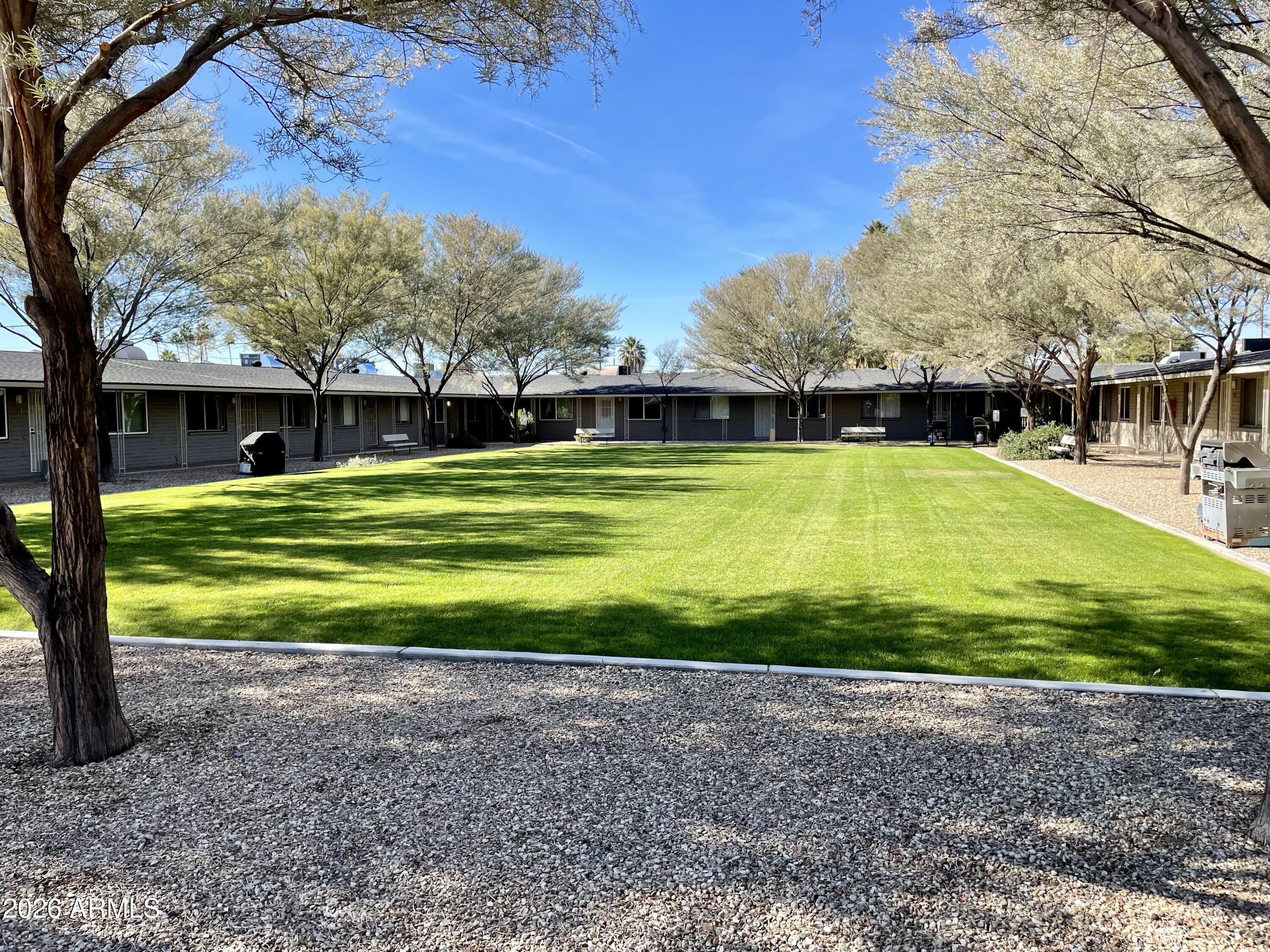 6819 North 12th Street, Unit 9 Phoenix, AZ 85014 - Photo 16 of 21 a view of a big yard with a large trees